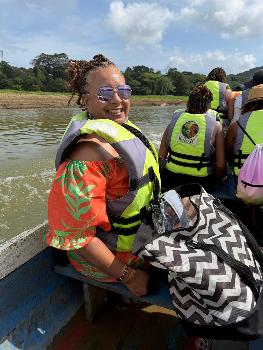 Member smiling on the river boat in a life vest