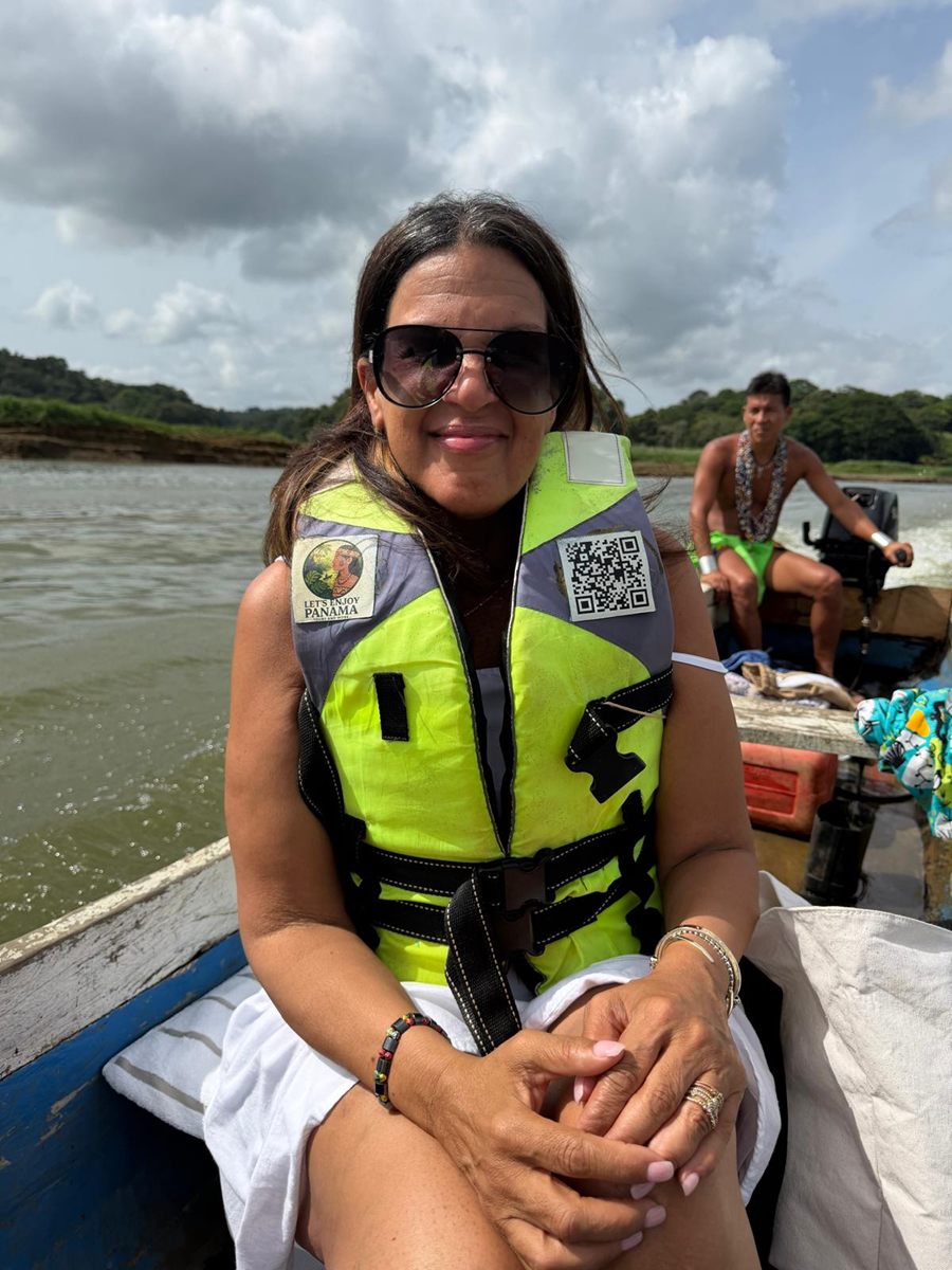 Member on the river boat with the Emberá boatman behind