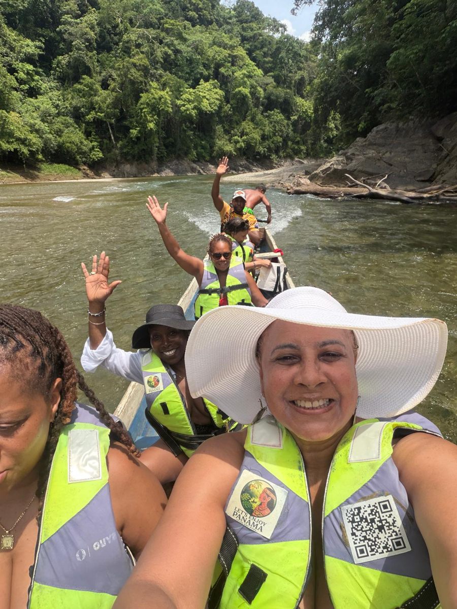 Members waving from the boat on the Chagres river