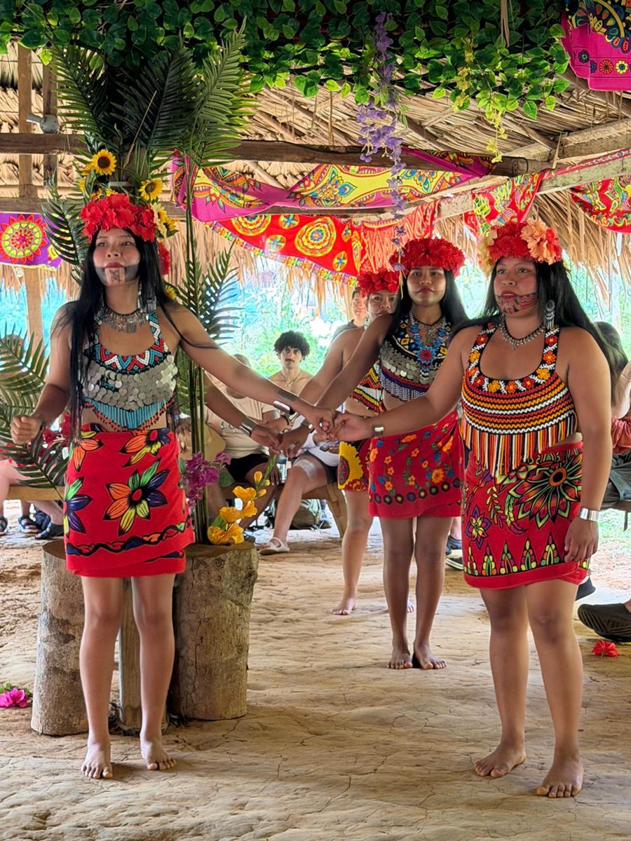 Emberá dancers in traditional red dress and flower headdresses
