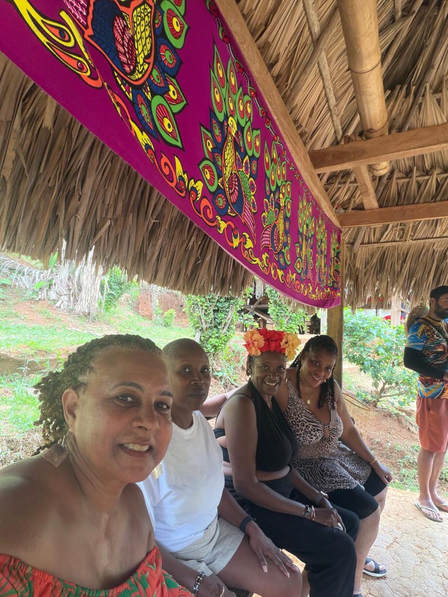 Group selfie beneath the community's mola textiles